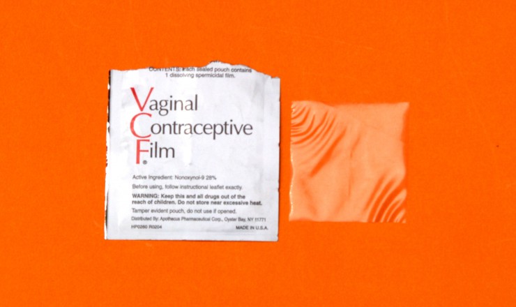 A photo of an opened package of Vaginal Contraceptive Film, featuring both the wrapper and the film. They are on an orange background.
