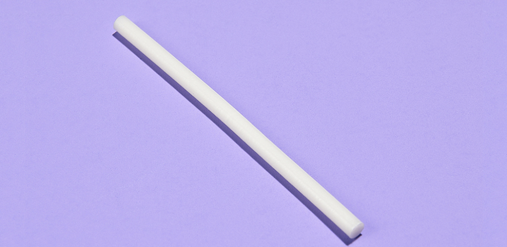 A photo of a birth control implant on a lavender background.